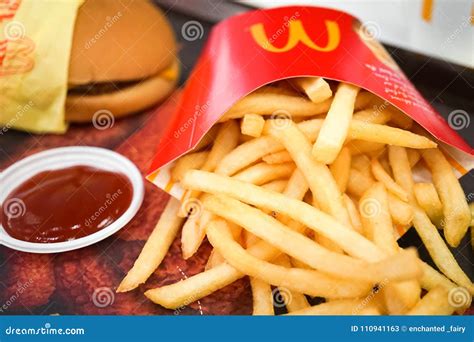 Mcdonalds` Fast Food With Potato Fries And Cheese Burger Editorial