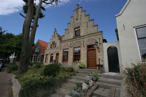 An Old Brick Building With Steps Leading Up To The Front Door And Side