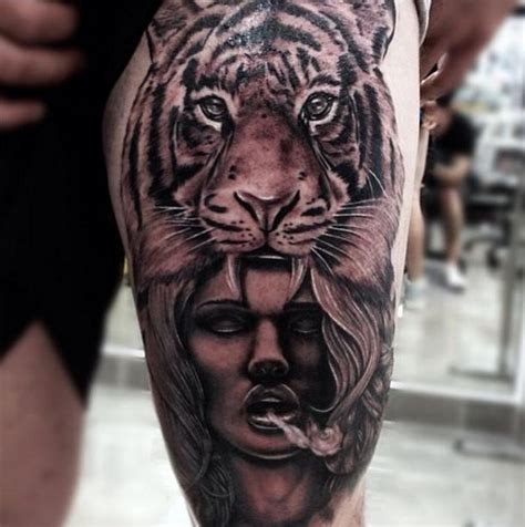 Impressive looking black and white thigh tattoo of tribal woman in tigers skin - Tattooimages.biz