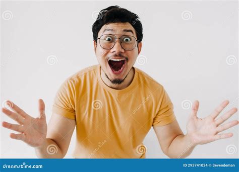 Wow And Happy Surprised Face Of Asian Man In Yellow T Shirt Isolated On