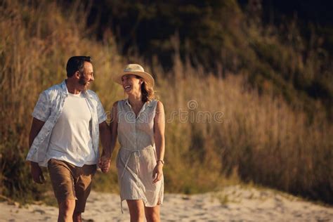 You Know Just How To Make Me Happy An Affectionate Mature Couple Taking A Walk On The Beach