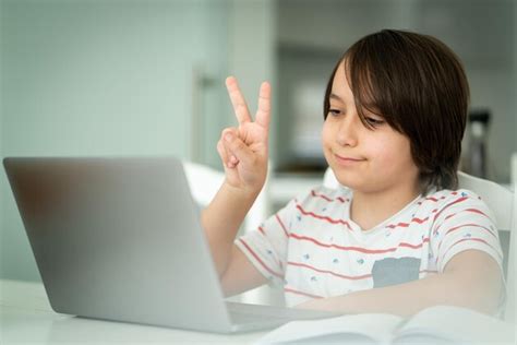 Premium Photo Child Using Laptop At Home Indoors