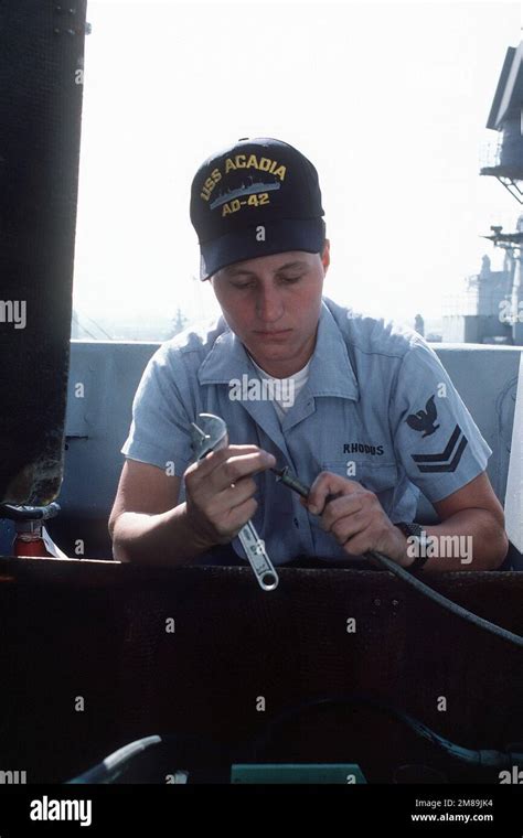 A Female Crew Member Services A Cable Aboard The Destroyer Tender Uss