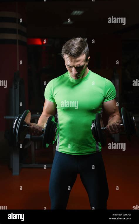 Closeup Portrait Of A Muscular Man Workout With Barbell At Gym