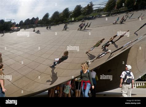 The Chicago Bean With People Looking At Their Reflections Stock Photo