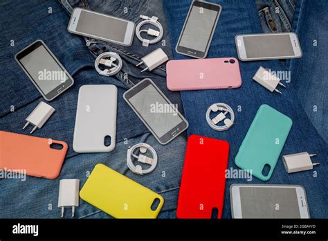 Texture Of Mobile Phone Accessories On A Denim Background Stock Photo