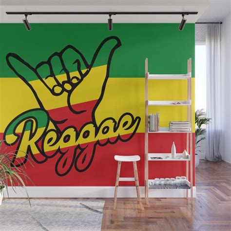 a raspberry wall mural with the word reggae painted on it and a hand in ...