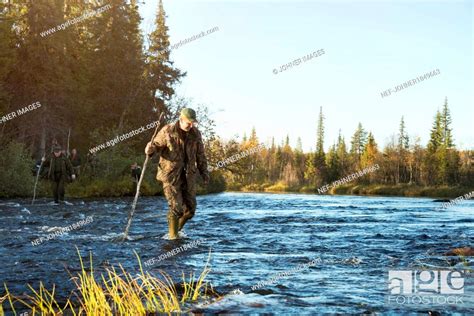 Hunters crossing river, Stock Photo, Picture And Royalty Free Image ...