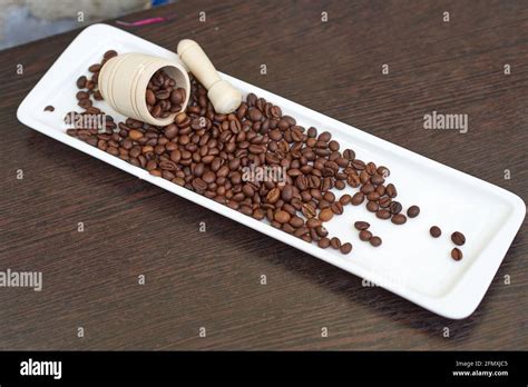 Coffee Beans with wooden mortar and Pestle Stock Photo - Alamy