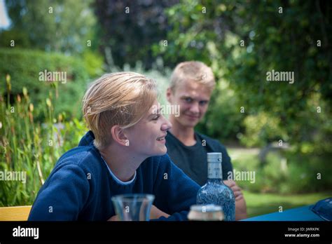 Two Blonde Brothers Having A Drink In The Garden Stock Photo Alamy