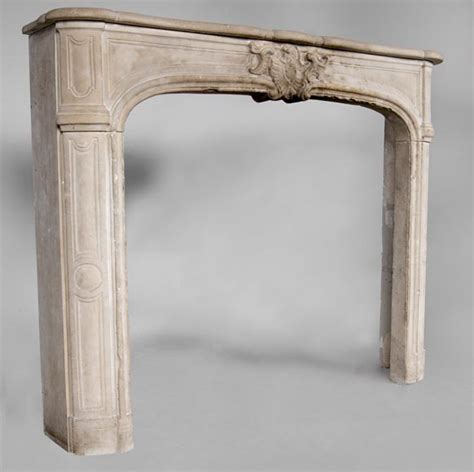 An Antique Louis Xv Style Fireplace Made Out Of Stone With Large