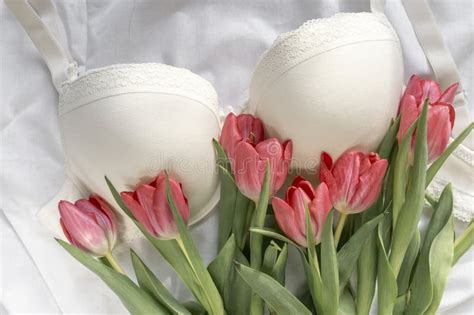 Gentle White Lace Bra On The Bed With Tulips Women Tender Lingerie Underwear Stock Photo