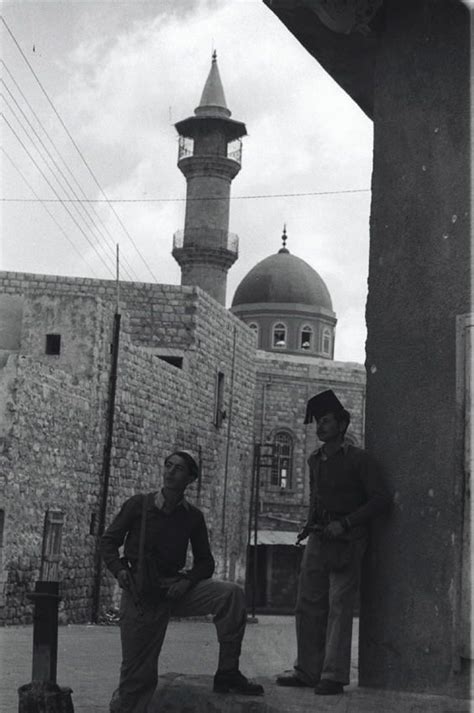 Israeli soldiers stand near a mosque during the battle of Haifa. 1948 ...