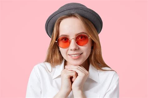 Portrait Of Happy Delighted Female Model In Round Red Sunglasses And