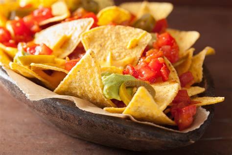 Nachos Loaded With Salsa, Guacamole, Cheese And Jalapeno Stock Photo ...