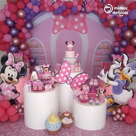 A Birthday Party With Minnie Mouse Decorations And Balloons