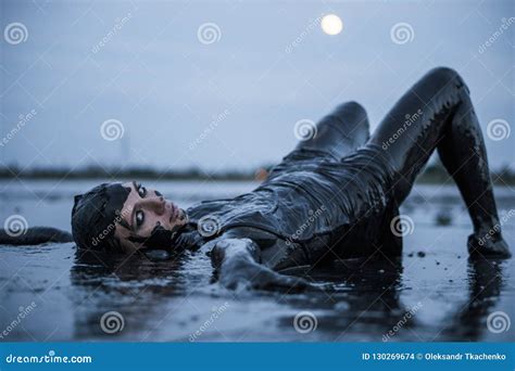 Adorable Slender Blonde Lays Smeared In A Black Mud Looks Like Petroleum Oil Stock Photo Image