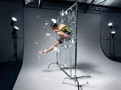 A Man Is Jumping Through A Broken Glass