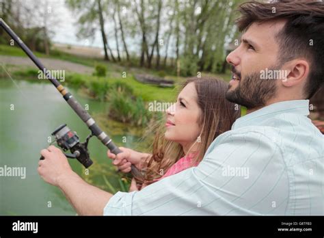 Young Couple Fishing Together In Lake Stock Photo Alamy