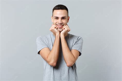 Retrato De Sonriente Joven Guapo En Ropa Casual De Pie Apretando Los