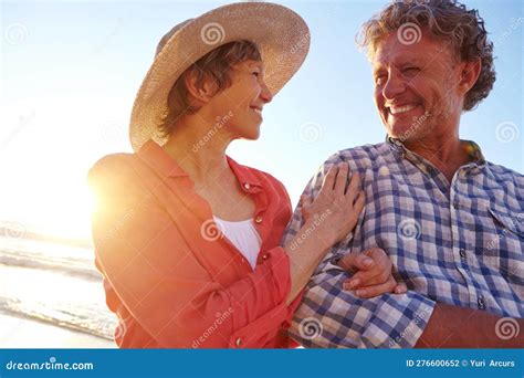 Sunset Romance A Mature Couple Enjoying A Late Afternoon Walk On The Beach Stock Photo Image