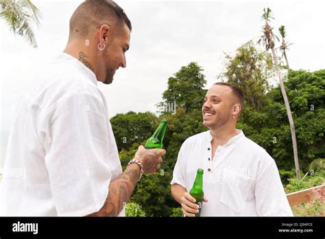 Smiling Gay Couple Drinking Beer While Talking Outdoors Stock Photo Alamy