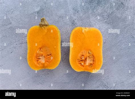 Butternut Squash Cut In Half On Grey Background Stock Photo Alamy