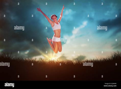 Composite Image Of Gorgeous Fit Blonde Jumping With Arms Out Stock