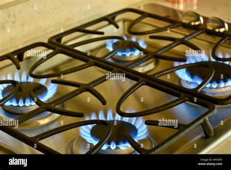 A Gas Stove Top Turned On With Flames Present Stock Photo Alamy