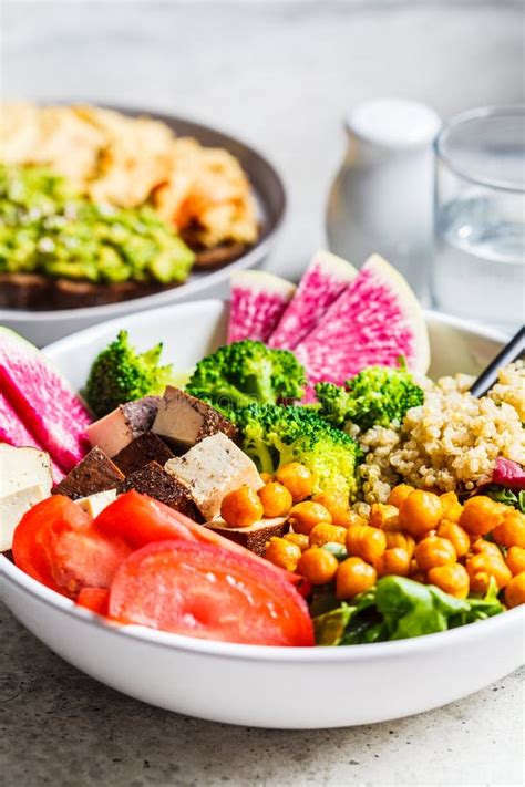 Buddha Bowl With Quinoa Fried Chickpeas Smoked Tofu And Vegetables In White Plate Healthy