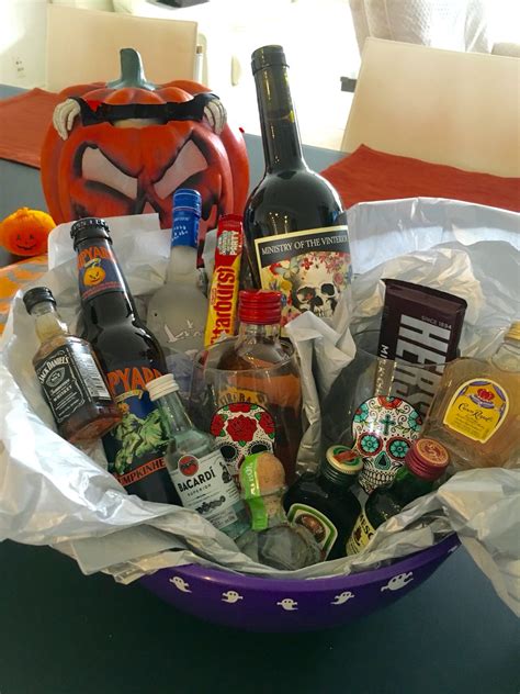 a purple bowl filled with alcohol bottles and halloween decorations