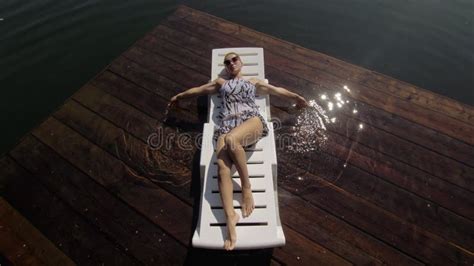 Woman Sit On A Sunbed In Sunglasses And Swimming Suit Girl Rest On A