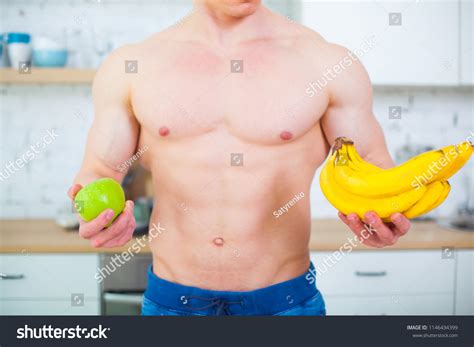 Muscular Man Naked Torso Kitchen Fruit Stock Photo