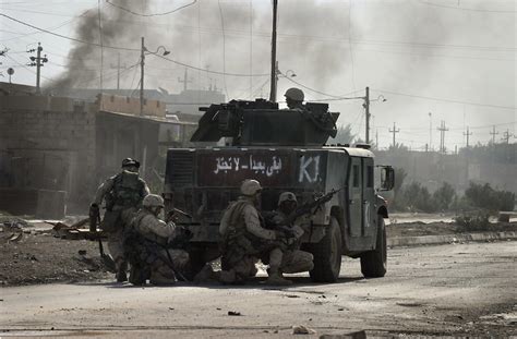 [Iraq] U.S Marines take cover and return fire from behind a Humvee ...