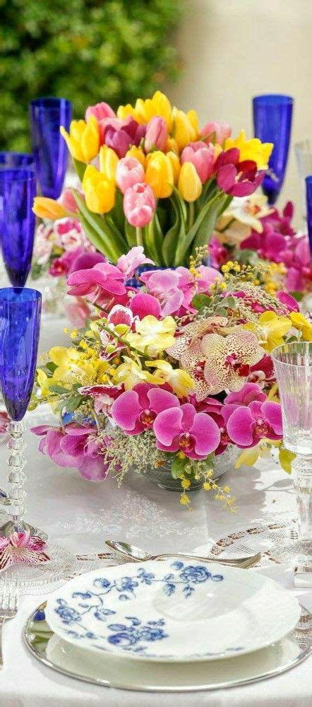 A Table Topped With Lots Of Purple And Yellow Flowers