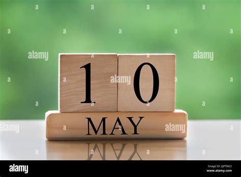 May 10 Calendar Date Text On Wooden Blocks With Blurred Nature