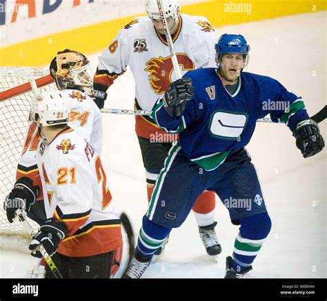 Vancouver Canucks Brendan Morrison Celebrates An Assist On Team Mate Ed