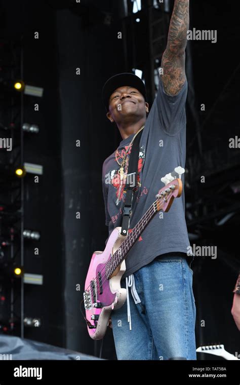 Bass Guitarist Franz Lyons Is Shown Performing On Stage During A Live