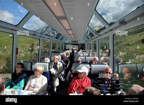 The Glacier Express Train Is Driving Across The Swiss Alps And Through