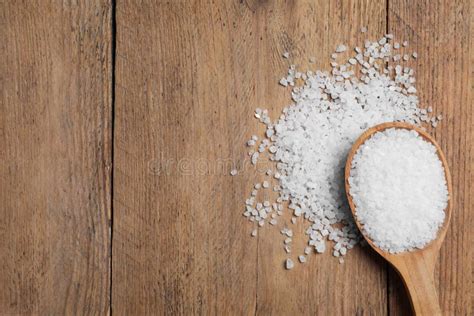 Spoon And Heap Of Natural Sea Salt On Wooden Table Top View Space For