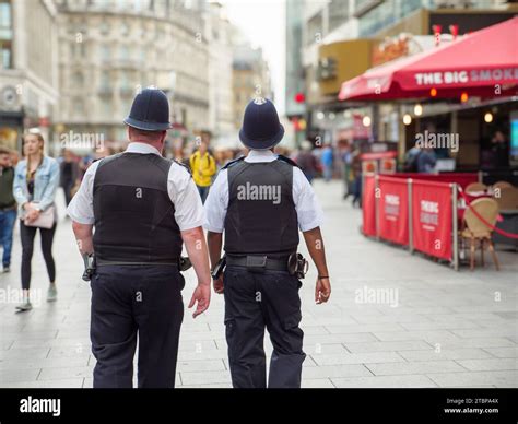 Two Metropolitan Police Officers On Patrol On The Streets Of The West