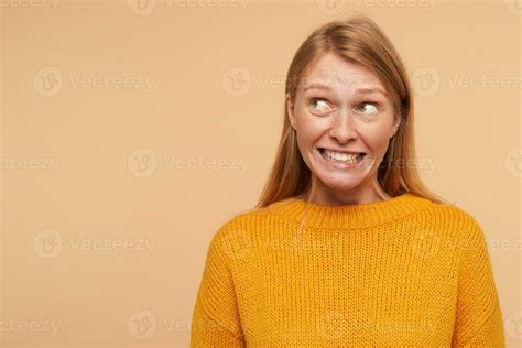 Puzzled Young Lovely Long Haired Redhead Female With Natural Makeup