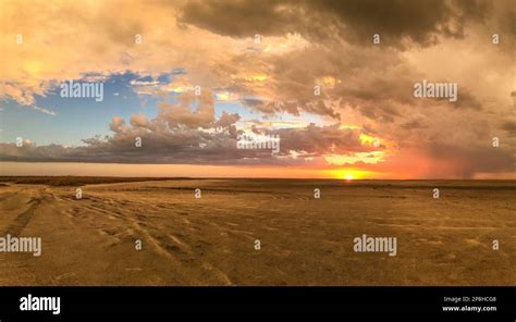 African Sunset Above The Salt Pan Flat Landscape Panorama View Of Sun