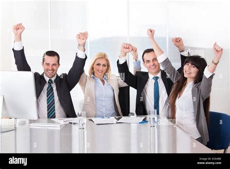 Happy Business Team In Office Celebrating Success Stock Photo - Alamy