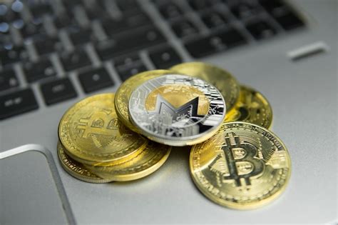 Premium Photo Monero Coin On Pile Of Golden Coins And Laptop Keyboard