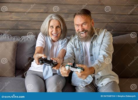 Mature Couple Playing Video Games And Looking Excited Stock Photo Image Of Online Mature