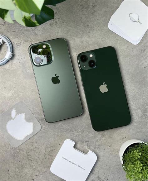 Two Green Iphones Sitting Next To Each Other On Top Of A Cement Surface