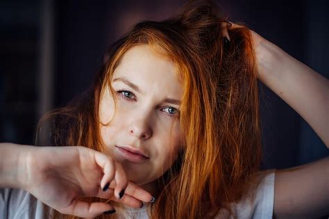 Premium Photo Sexy Brunette Touches Her Long Hair And Looks At Camera