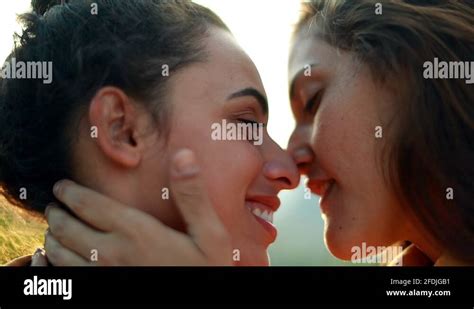 Beautiful Tender Loving Kiss Between Two LGBT Lesbian Couple With Lens Flare Stock Video Footage