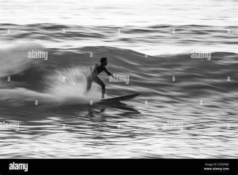 Local Surfer Riding Waves With A Short Board In Furadouro Beach